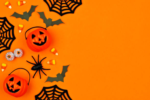 istock Halloween decor side border over an orange background with copy space 1174280399