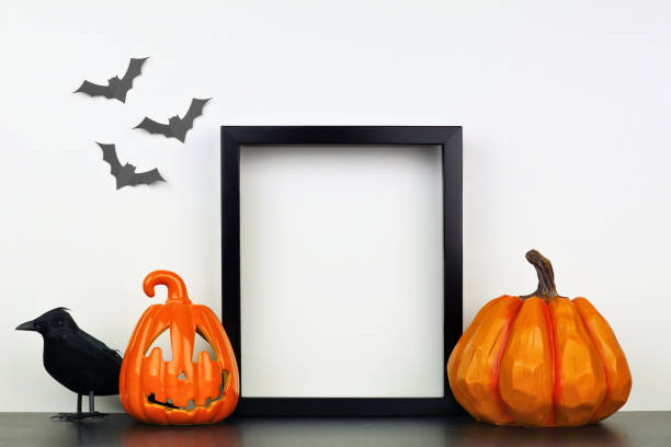 istock Mock up black frame with Halloween Jack o Lantern, pumpkin and crow decor on a shelf against a white wall 1174281287