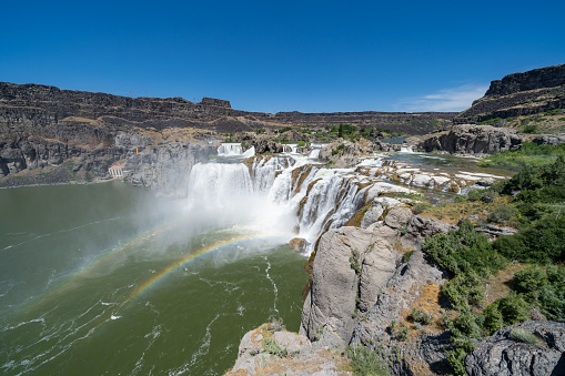 Extreme wide angle view of Shoshone Falls waterfall with rainbow in Twin Falls Idaho