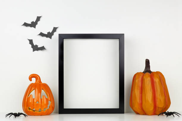 istock Mock up black frame with Halloween Jack o Lantern and pumpkin decor on a shelf against a white wall 1174281780