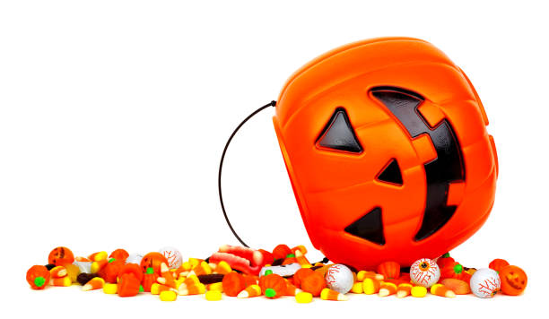 istock Halloween Jack o Lantern bucket with spilling candy isolated on white 1174282346