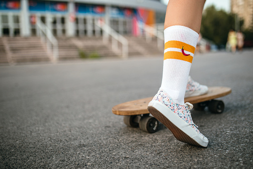 Skateboarder teenager girl riding skateboard in the city