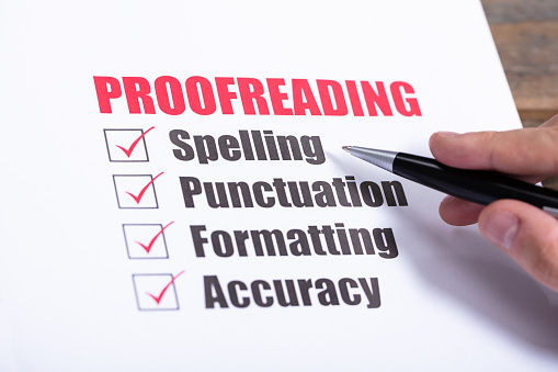 Proofreading Checklist Concept. Man Crossing Checkboxes At Desk