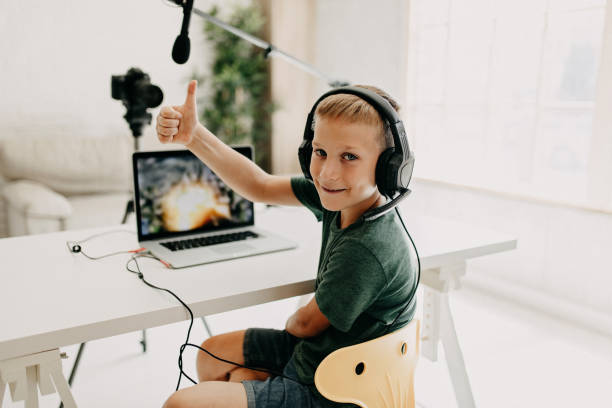 istock Boy in headphones playing video game on laptop 1174294216