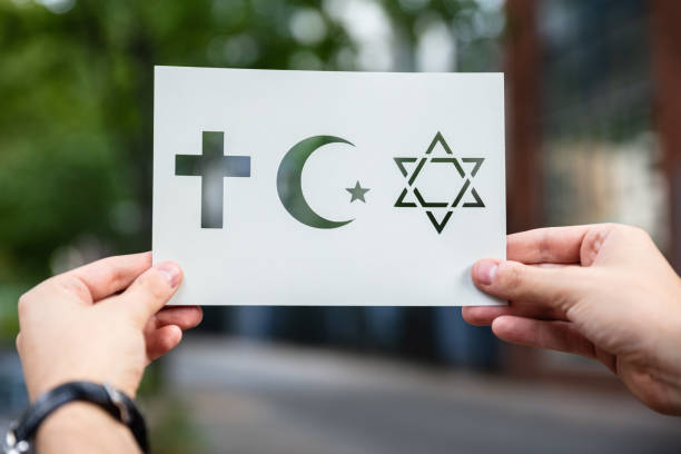 istock Hands Holding Paper With Cutout Religion Symbols 1174294225