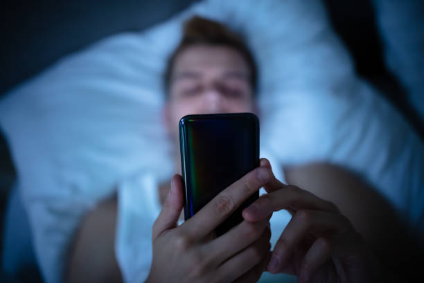 istock Man In Bed With Mobile Phone 1174294357