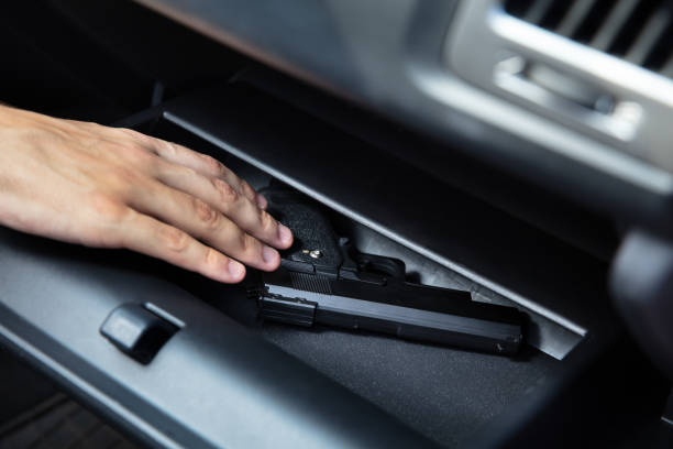 Driver Taking Handgun From Glovebox Driver Taking Handgun From Glovebox Compartment Inside Car glove box stock pictures, royalty-free photos & images