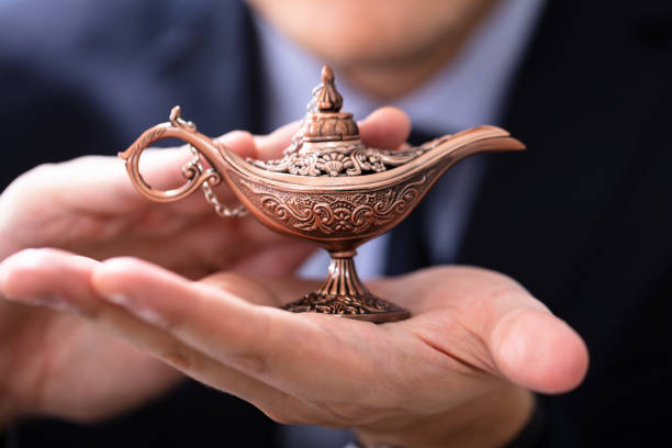 Antique Aladdin arabian nights genie style oil lamp with soft light white smoke, Dark background. Lamp of wishes concept