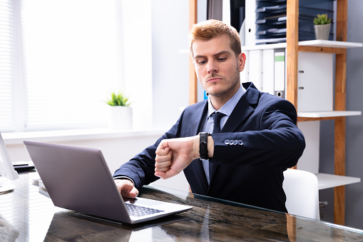 Efficient Businessman Looking At Watch Checking Time