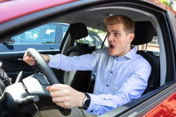 istock Shocked Young Man Driving Car 1174295571