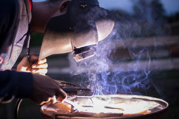 istock Industrial Worker in action welding close up 1174296150