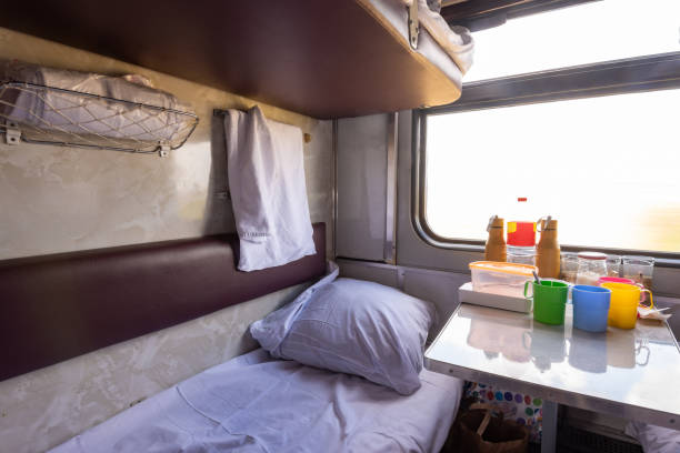 istock Empty bottom bunk in a reserved seat carriage and table with dishes 1174298289