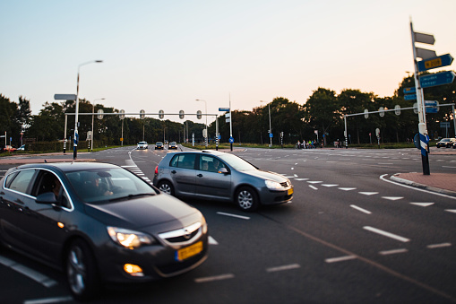 Haarlem, Netherlands - Aug 26, 2019: Cinematic view of Kleverlaan street with Opel and Volkswagen car entering highway with defocused by the tilt-shift lens background