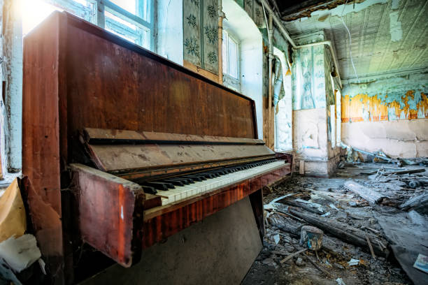 istock Old broken piano in ruined abandoned building 1174300132