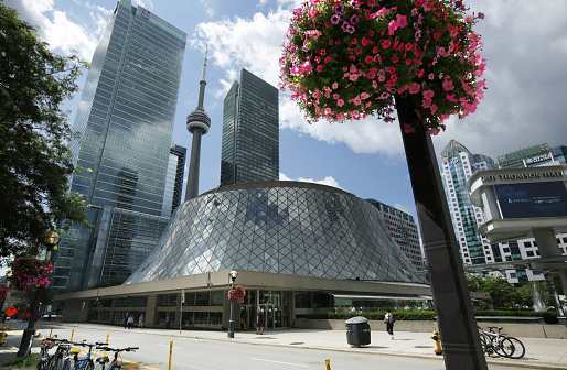 Toronto, Canada - August 19, 2019: View from King Street West at Simcoe Street includes Roy Thomson Hall, the CN Tower and hotel and office skyscrapers in the Entertainment District.