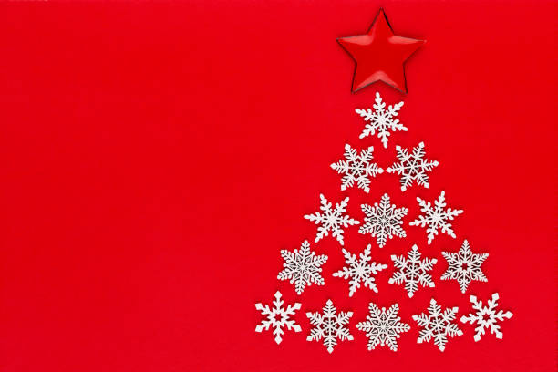 istock White snow flake decoration on red background. Flat lay, top view 1174301855
