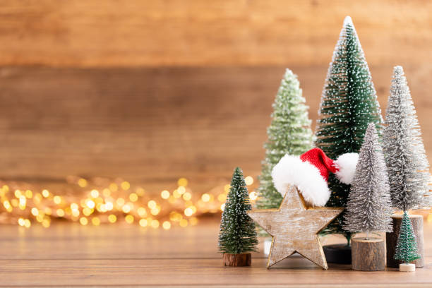 istock Colorful Christmas tree on wooden, bokeh background. 1174301958