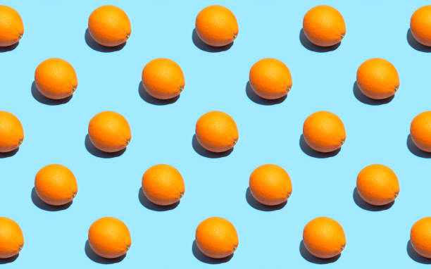 istock Fruit pattern of fresh orange on blue background. Top view. Summer concept. Collage. Healthy eating and dieting concept. 1174302044