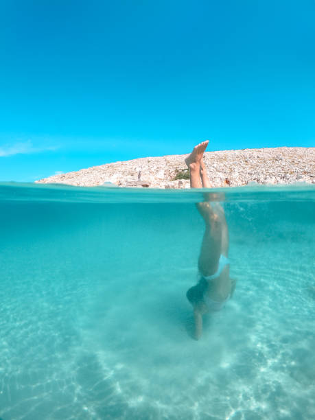 istock Woman swimming underwater 1174302065