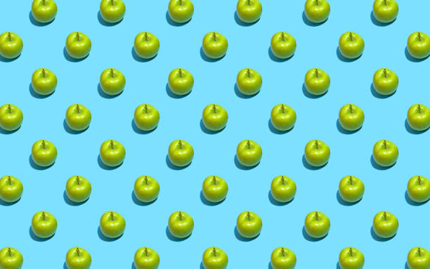 Fruit pattern of fresh green apples on blue background. Top view. Summer concept. Collage