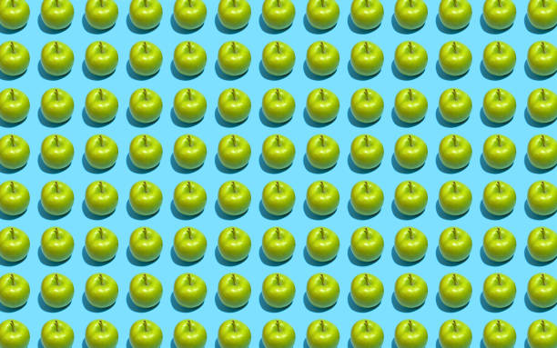 istock Fruit pattern of fresh green apples on blue background. Top view. Summer concept. Collage 1174302269