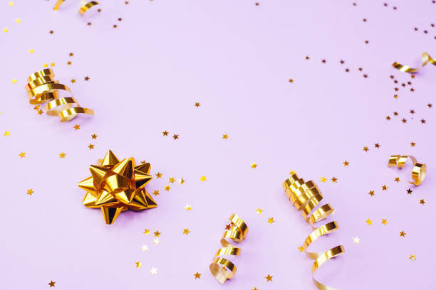 istock Golden decorations and sparkles on pale purple background 1174305989