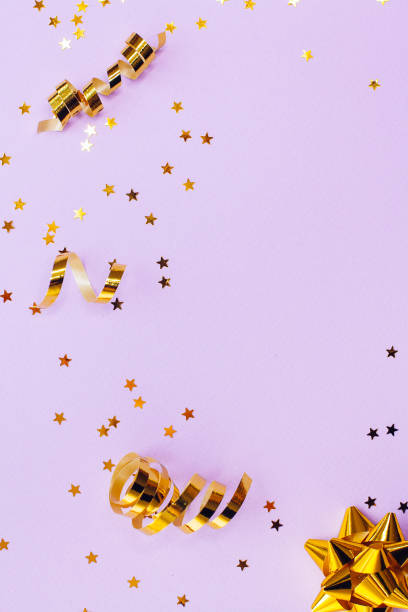 istock Golden decorations and sparkles on pale purple background 1174306001