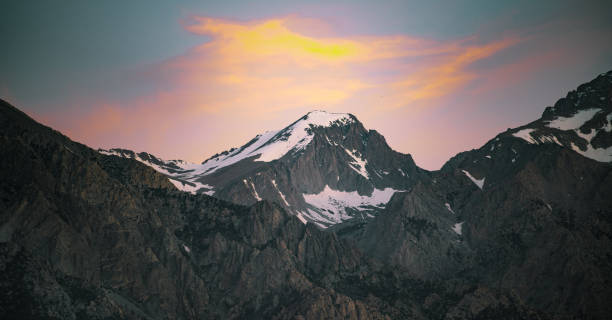 istock Sunrise On A Snowy Mountain 1174308784
