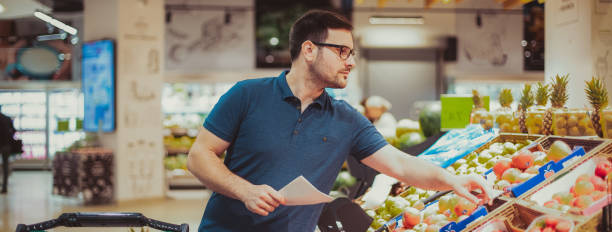 istock Middle age man buying vegetables at the market 1174321847
