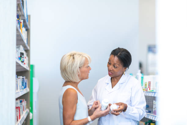 istock Female pharmacist assisting woman in pharmacy 1174321978