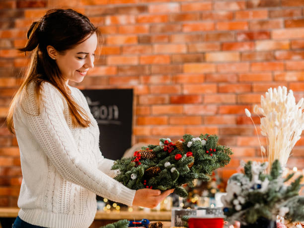istock festive gift workshop florist fir tree wreath 1174322765
