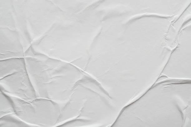 istock Blank white crumpled and creased paper poster texture background 1174323123