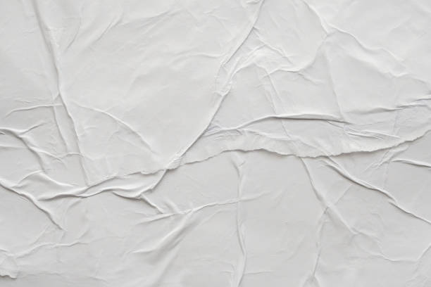 istock Blank white crumpled and creased paper poster texture background 1174323124