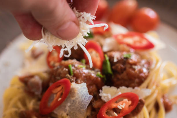 Spaghetti with meatballs and grated parmesan at plate
