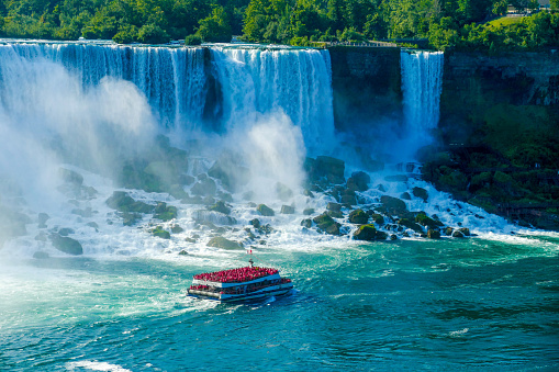 The Hornblower Cruise passing by the American Falls which lies entirely on the US side of Niagara Falls, as it makes its way to the Horseshoe Falls on the Canadian side.