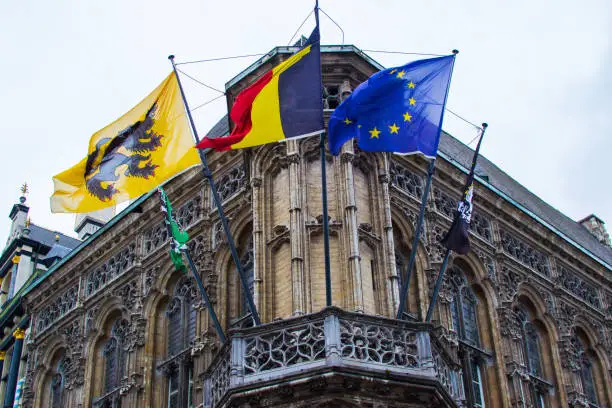 Photo of Town Hall (Stadhuis) in Ghent, Belgium, Europe, with flags of the city, Flanders, Begium and Europe