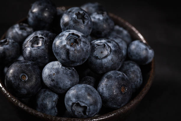 istock Blueberries in a brown ceramic bowl placed on a black tablecloth 1174330399