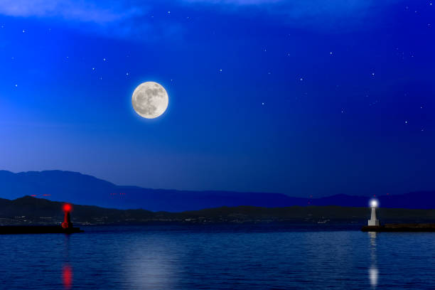 istock Full moon rising over the sea and the lighthouse. 1174332011