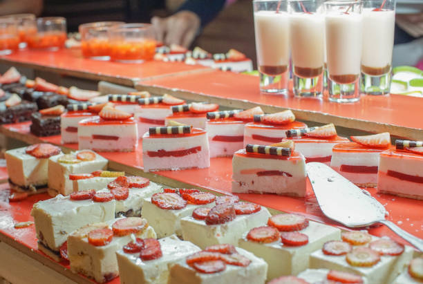 a variety of cakes at a buffet, strawberry short cake, vanilla sponge cake and double chocolate cake