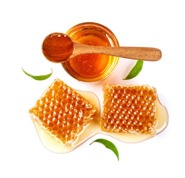 istock Honeycomb with jar and honey spoon and leaf isolated on white background 1174335561