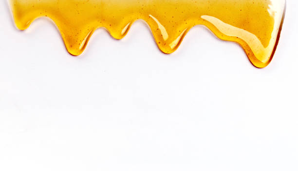 dripping honey seamlessly repeatable desde la parte superior sobre blanco con copyspace y texto - honey fotografías e imágenes de stock