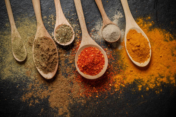 istock Herbs and spices and the spoon over black stone background. Top view 1174336318