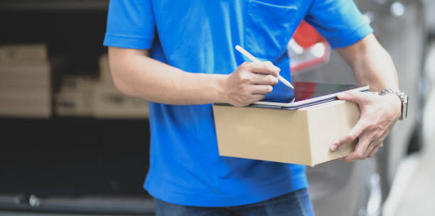 istock Professional delivery man preparing the products to customer 1174339858