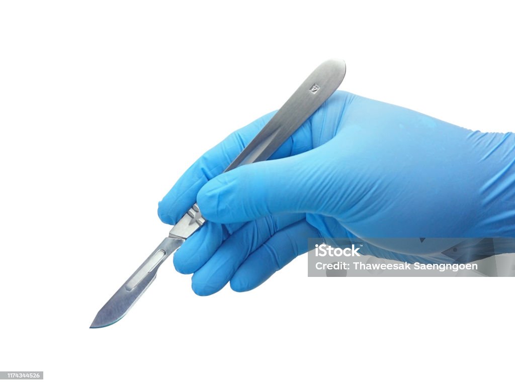 Hand of surgeon in blue medical glove holding a scalpel with blade Hand of surgeon in blue medical glove holding a stainless steel scalpel handle with blade isolated on white background with clipping path Scalpel Stock Photo