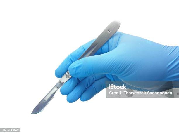Hand Of Surgeon In Blue Medical Glove Holding A Scalpel With Blade Stock Photo - Download Image Now