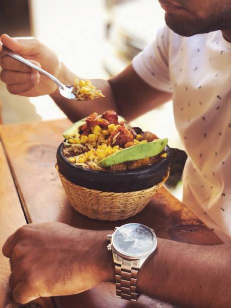istock Man eating colombian food 1174346769