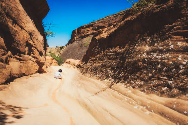 A little Chinese girl play in Danxia landform ground.