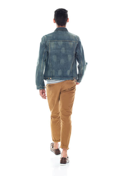 Rear view / full length / one person of 20-29 years old adult handsome people / tall person african ethnicity / african-american ethnicity male / young men walking in front of white background wearing denim jacket / boat shoe / cool attitude vista trasera / longitud completa / una persona de 20-29 años de edad adulto guapo personas / persona alta etnia africana / etnia afroamericana hombre / hombres jóvenes caminando delante de fondo blanco usando chaqueta de mezclilla / zapato de barco / ac