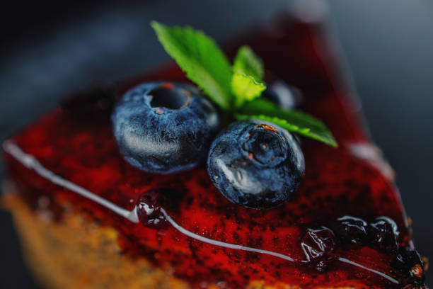 Cake with berry fruits, chia cereals and nuts isolated on black background