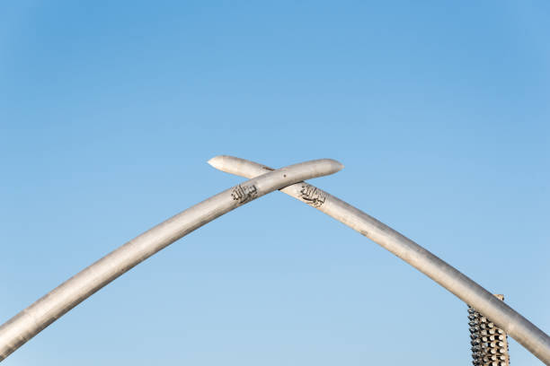 Detail part from a metallic arches formed from pipe of the Hoheward Halde horizon observatory in front of a dramatic cloudy sky